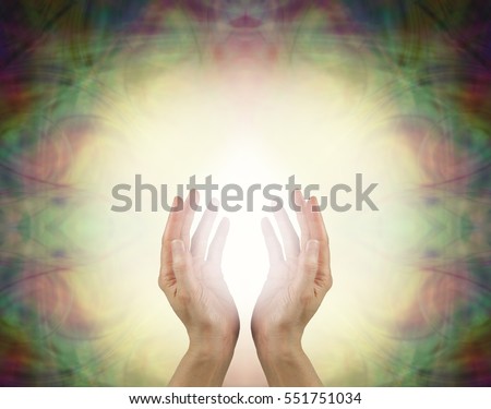 Prana Healing Energy Field - Female energy worker with hands outstretched and open upwards sensing white healing energy on pale yellow background with dark vignette edges