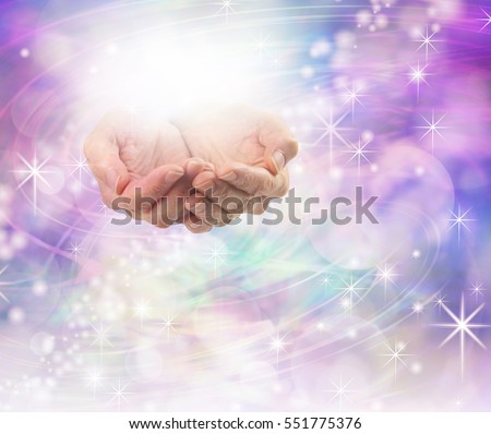 Divine Light Healing Energy - female hands cupped with a ball of bright energy above on a beautiful sparkling purple pink bokeh energy field background with plenty of copy space