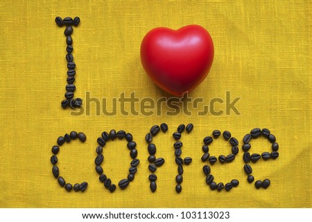 I love coffee concept phrase made of raw coffee beans over yellow tablecloth background