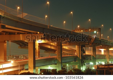 night illumination on the modern hanged up highway in Tokyo, Japan