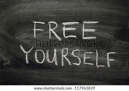 free yourself phrase handwritten on school blackboard