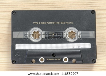 chrome type vintage audio cassette on the light wooden background