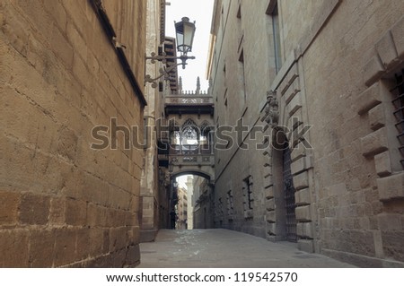 famous Gothic Quarter in barcelona with narrow medieval streets; focus on foreground wall