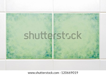 two square green tiles with white tiles around