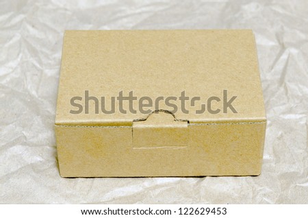 small carton box on wrinkled wrapping paper
