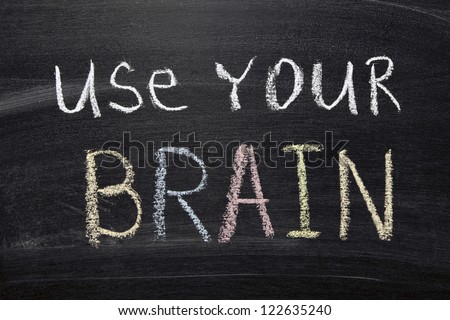 use your brain phrase handwritten on blackboard