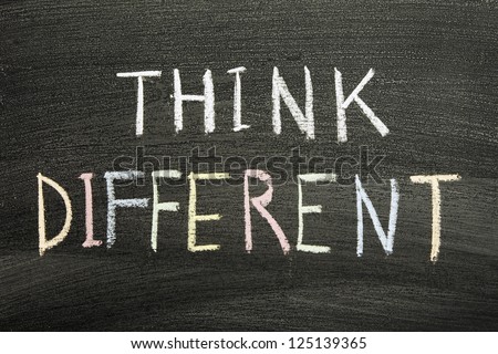 think different phrase handwritten on school blackboard