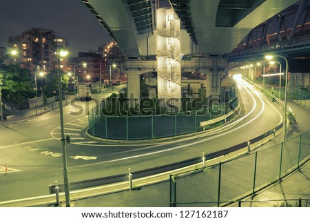 colors of night Tokyo with huge illuminated highway structure