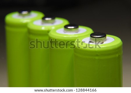 row of green rechargeable batteries with focus on front one