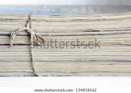 vintage magazines stack tied with old twine on white shelf