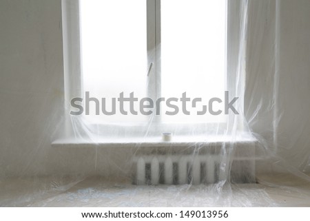 wall and window protected by plastic film in home renovation interior