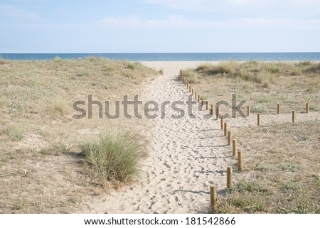 way to the empty sand  beach on Spanish coast