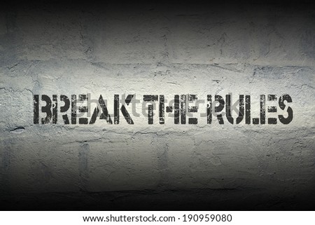 break the rules stencil print on the grunge brick wall with gradient effect
