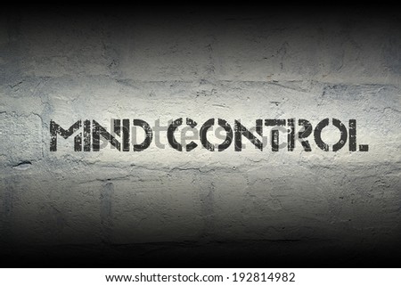 mind control stencil print on the grunge brick wall with gradient effect