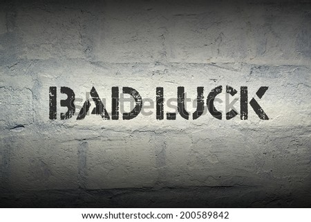 bad luck stencil print on the grunge brick wall with gradient effect