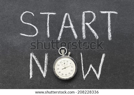 start now concept handwritten on chalkboard with vintage precise stopwatch used instead of O