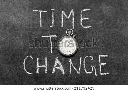 time to change concept handwritten on chalkboard with vintage precise stopwatch used instead of O
