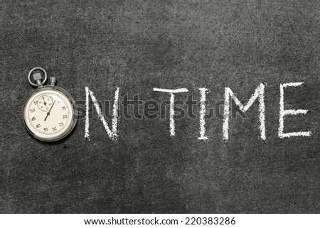 on time phrase handwritten on chalkboard with vintage precise stopwatch used instead of O