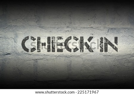 check in stencil print on the grunge white brick wall