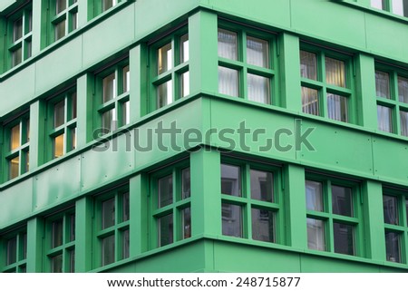 modern green building corner fragment with square windows