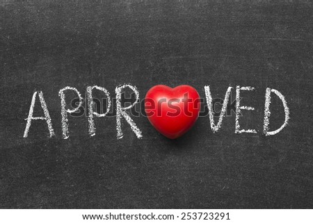 approved word handwritten on blackboard with heart symbol instead of O