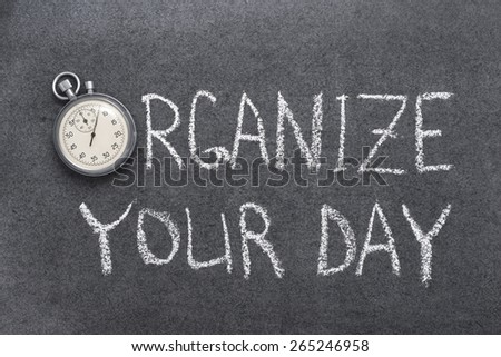 organize your day phrase handwritten on chalkboard with vintage precise stopwatch used instead of O