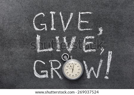 give, live, grow slogan handwritten on chalkboard with vintage precise stopwatch used instead of O