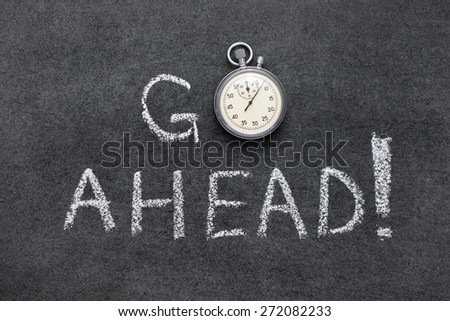 go ahead exclamation handwritten on chalkboard with vintage precise stopwatch used instead of O