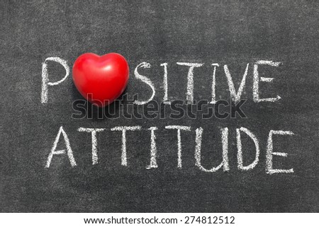 positive attitude phrase handwritten on blackboard with heart symbol instead of O