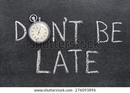 don\'t be late phrase handwritten on chalkboard with vintage precise stopwatch used instead of O