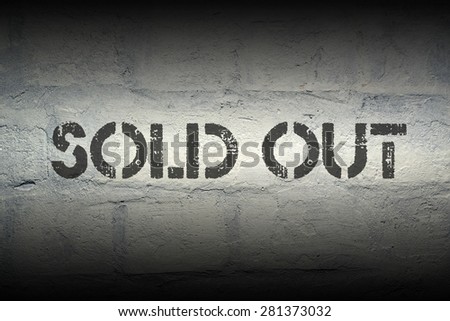 sold out stencil print on the grunge white brick wall