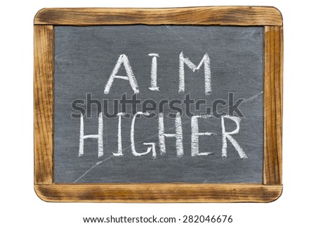 aim higher slogan handwritten on vintage slate chalkboard isolated on white