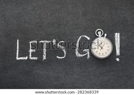 let\'s go exclamation handwritten on chalkboard with vintage precise stopwatch used instead of O