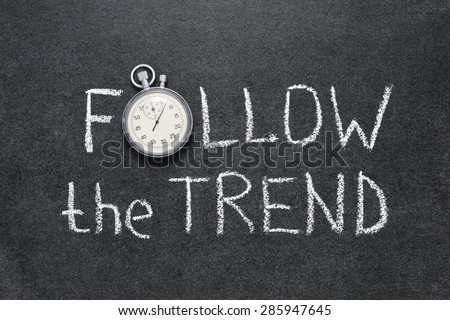 follow the trend phrase handwritten on chalkboard with vintage precise stopwatch used instead of O