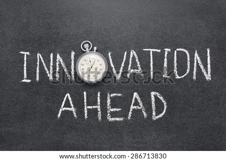 innovation ahead sign handwritten on chalkboard with vintage precise stopwatch used instead of O