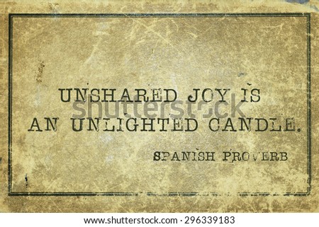 Unshared joy is an unlighted candle - ancient Spanish proverb printed on grunge vintage cardboard