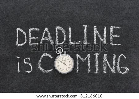 deadline is coming phrase handwritten on chalkboard with vintage precise stopwatch used instead of O