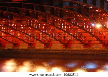 famous red Azuma bridge abstract reflection in night waters of Sumida river, Asakusa, Tokyo, Japan