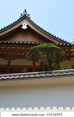 oriental temple background with traditional wall, temple roof and decoration bush