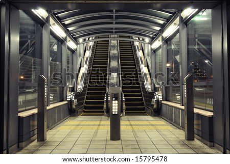 symmetrical interior with modern escalators at night time, Tokyo Japan
