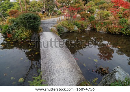 scenic bridge in autumnal japanese zen-garden in Kyoto