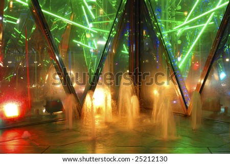 abstract play of night illumination colors in small fountain waters