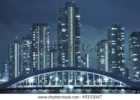 cold toned cityscape of night Tokyo, modern buildings at Tsukishima district and Eitai bridge