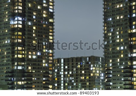 night image of illuminated residential skyscrapers with gap between buildings