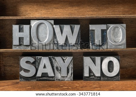 how to say no phrase made from metallic letterpress type on wooden tray