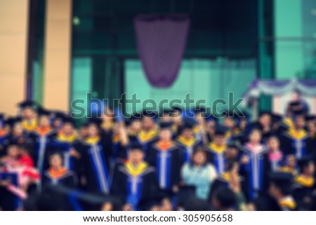 The Graduate Students Holding their diploma after graduation , background blurred.