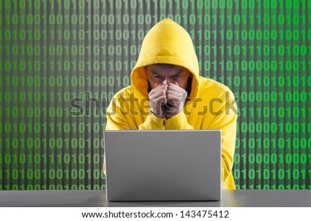 man in a yellow jacket working on the Internet. on gray background