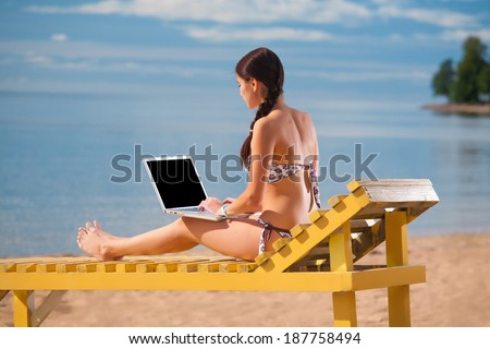 Woman laptop on the beach. Blank laptop screen.