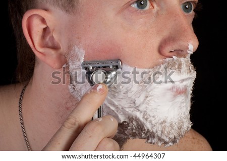 Men shaving faces. On the black background.
