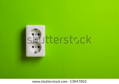 White electric socket on the wall. Close up.